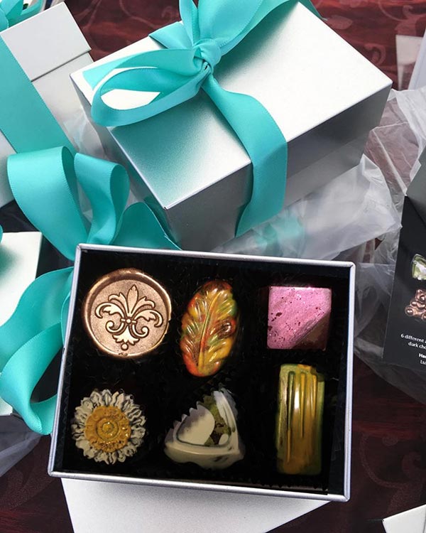 Luxx Chocolat chocolates with gift packaging and ribbon